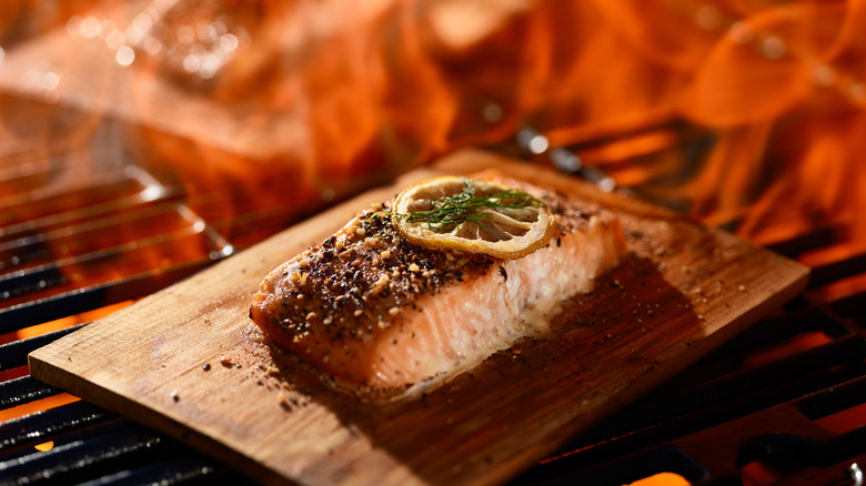 salmon cooking on wooden board