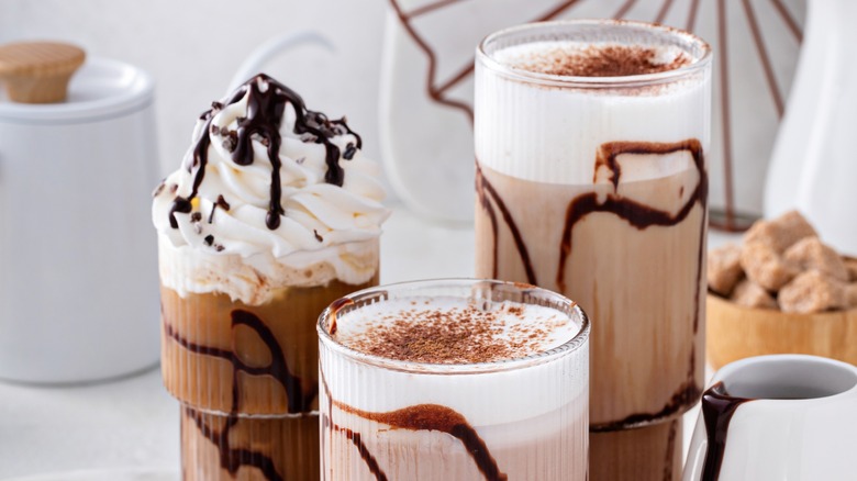 Three frozen chocolate drinks with toppings