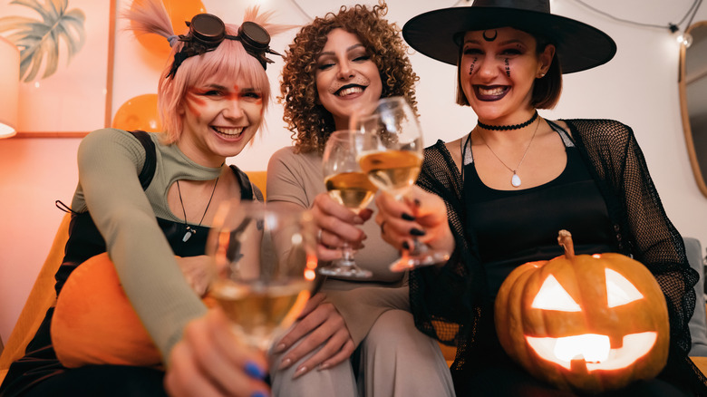 Friends enjoying wine at a Halloween party