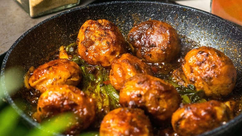 pan fried boiled eggs in iron skillet