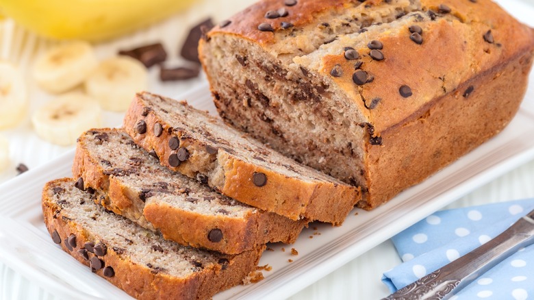 A half-sliced loaf of chocolate chip banana bread