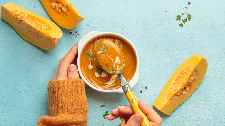 Butternut squash soup in bowl and spoon