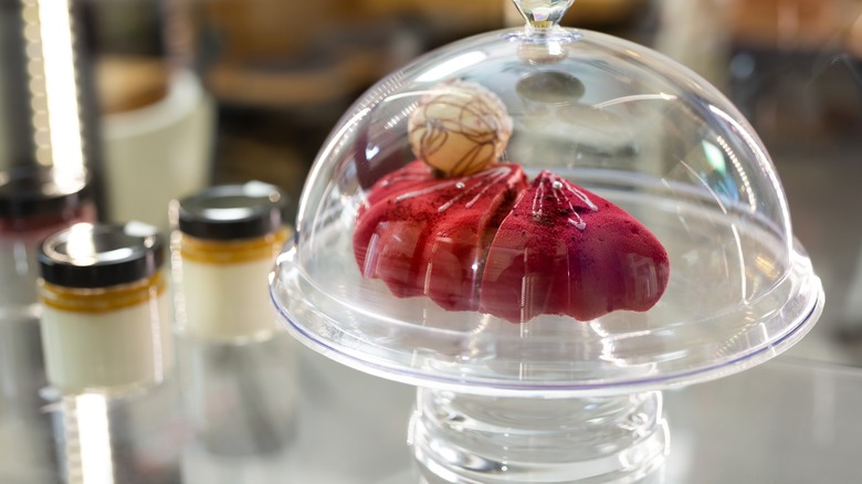 cake in glass stand with lid