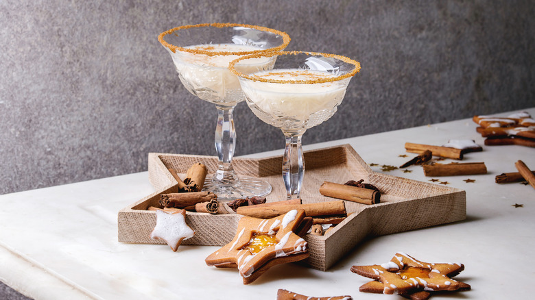 Two cocktails with cinnamon sugar rim and cookies