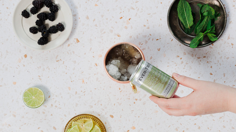 Adding ginger beer to copper mule glass
