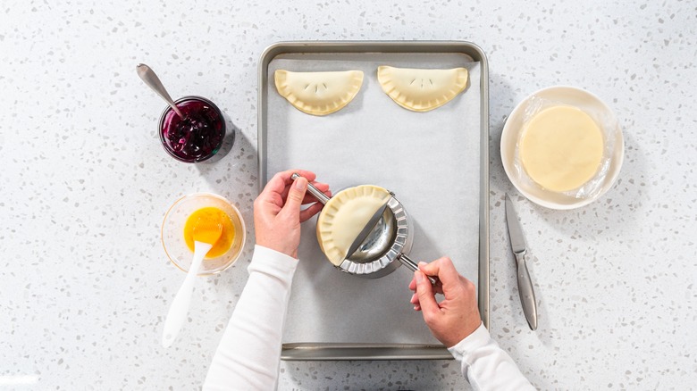 woman using an empanada press