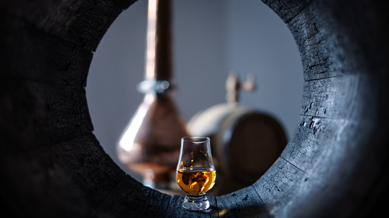 bourbon glass inside barrel distillery