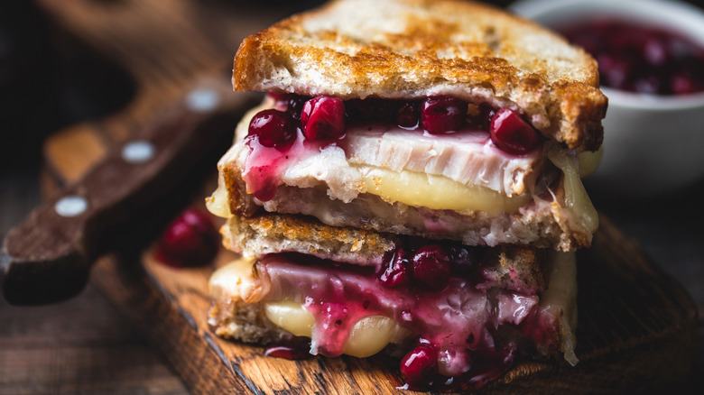 A grilled cheese with cranberry sauce and turkey