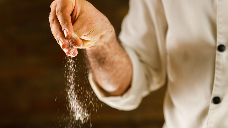 chef salting a dish