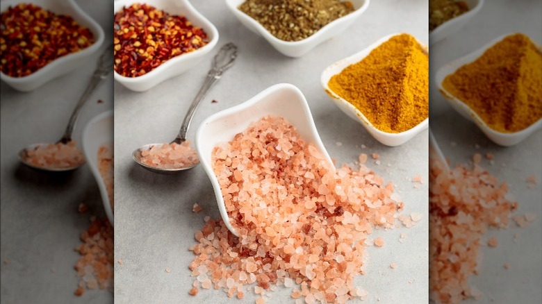 bowl of pink salt with chili flakes and other spices