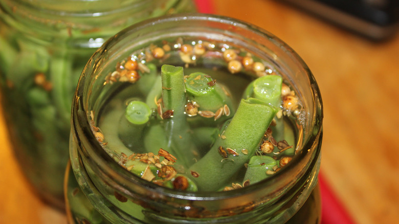 dilly beans pickling in a jar with spices