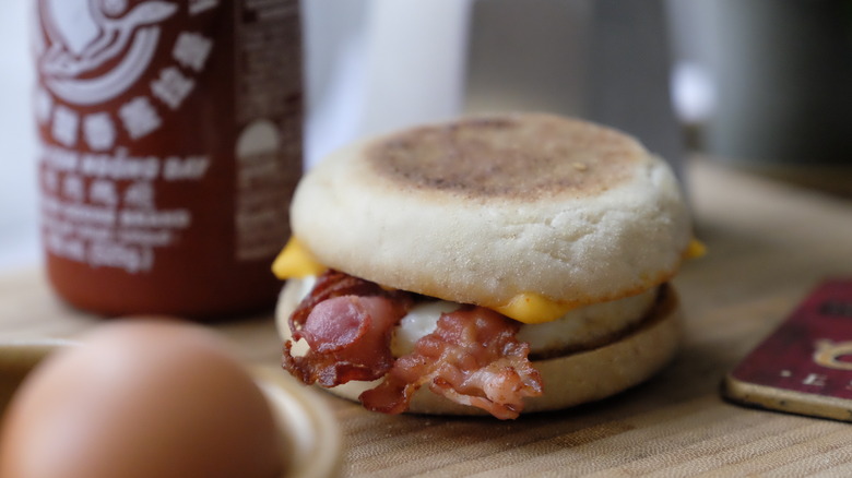 Breakfast sandwich by sriracha bottle