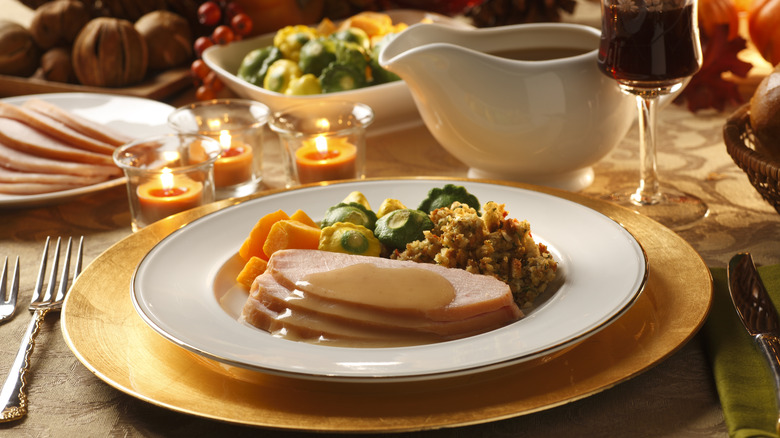 plate of thanksgiving dinner next to gravy boat