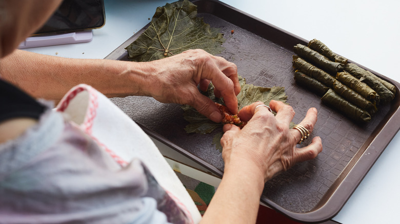 Woman making stuffed grape leaves