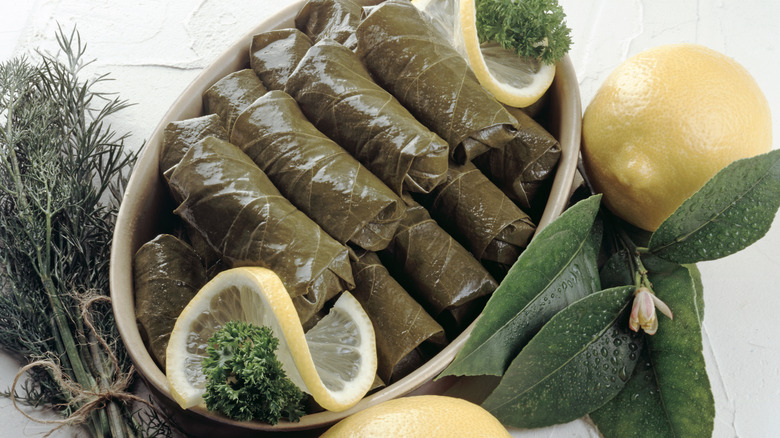 Container with dolmas and lemon