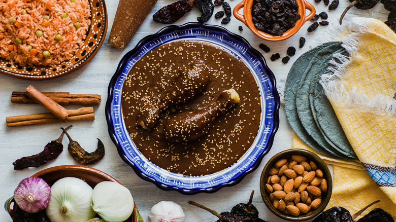 mole sauce on a plate next to ingredients