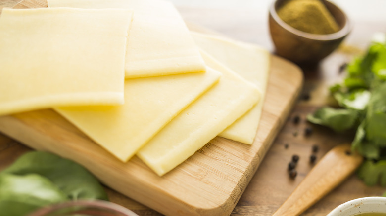 slices of cheese on a cutting board