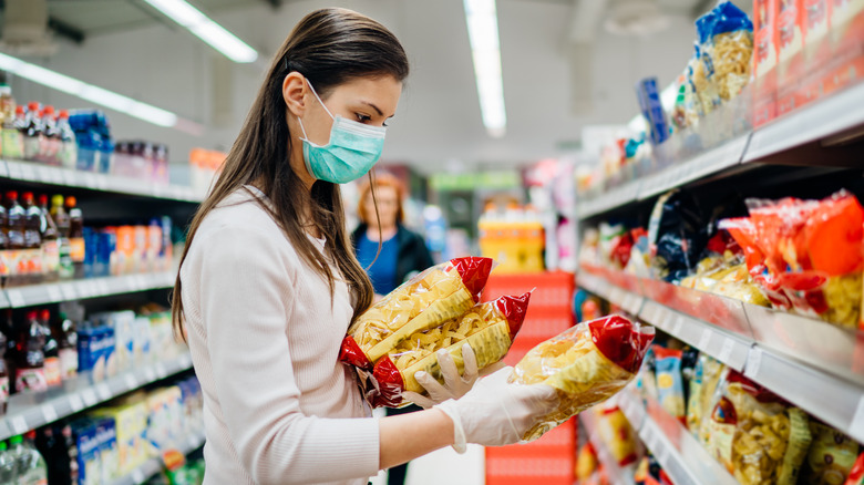 Person carrying bags of pasta