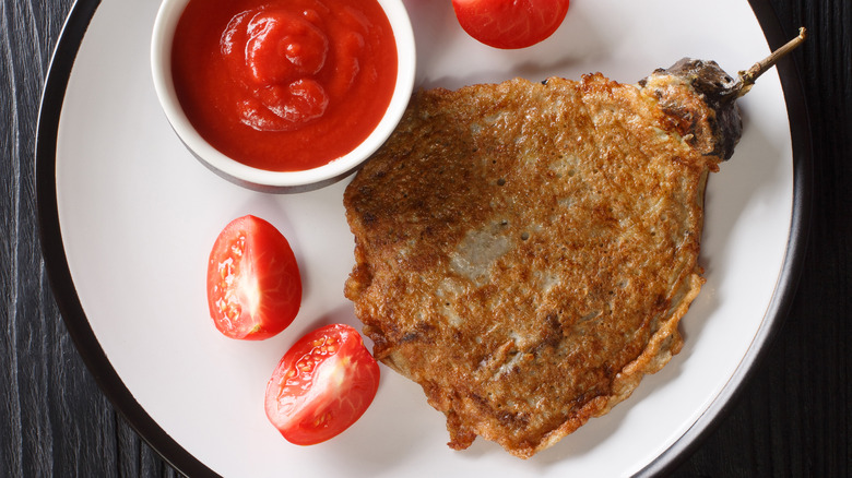 Tortang talong with chopped tomatoes.