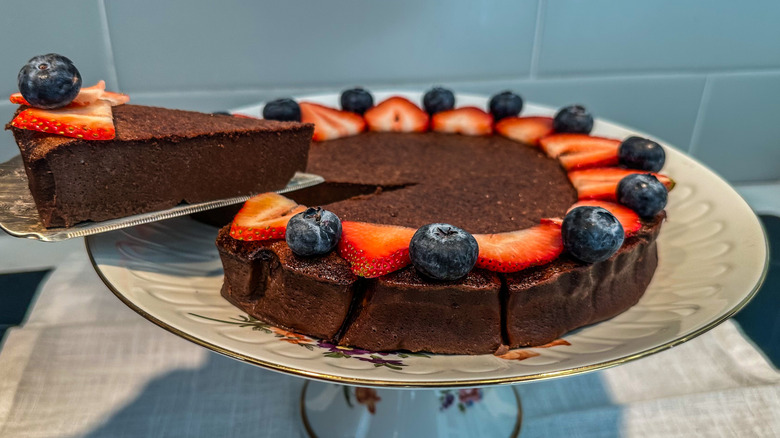 flourless chocolate cake on a cake stand