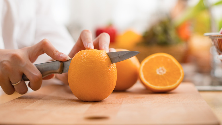 cutting oranges with a knife