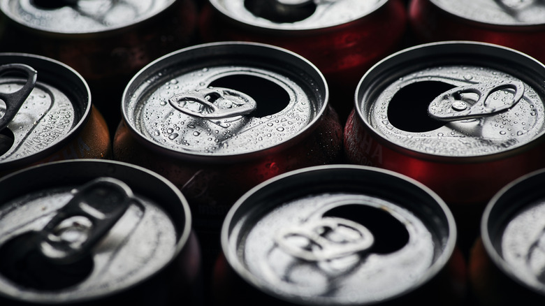 close up of open soda cans