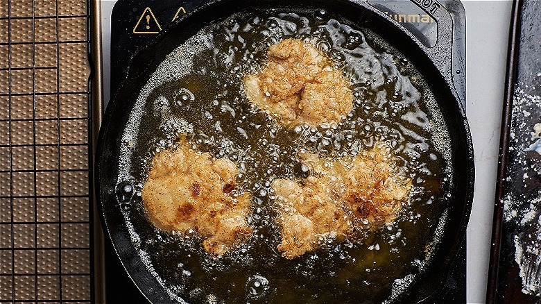 frying chicken in a skillet