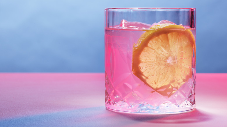 Pink-hued mocktail in a rocks glass