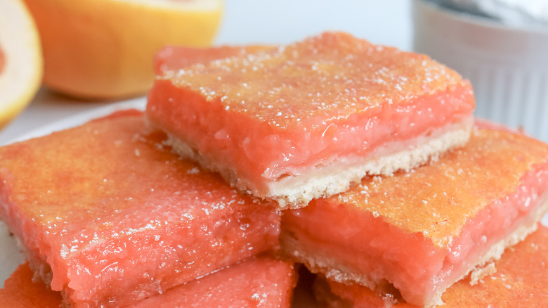 grapefruit bars stacked on a plate