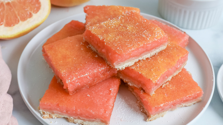 grapefruit bars stacked on a plate