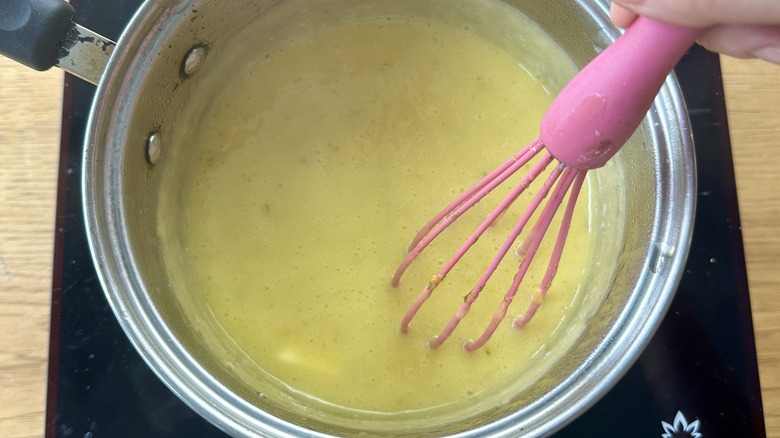 Whisking butter into curd