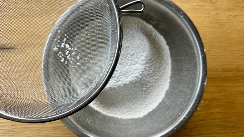 Sifting macaron ingredients