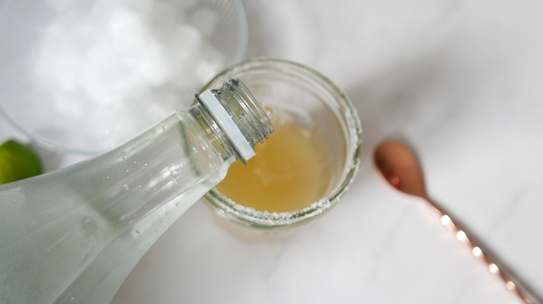 pouring soda water into glass