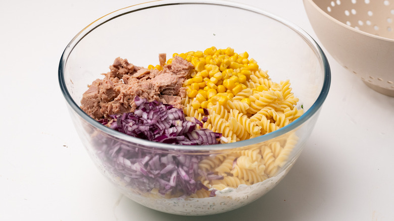 Mixing tuna pasta salad