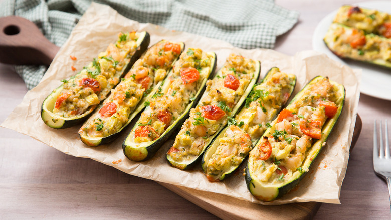 Loaded zucchini boats on wooden tray