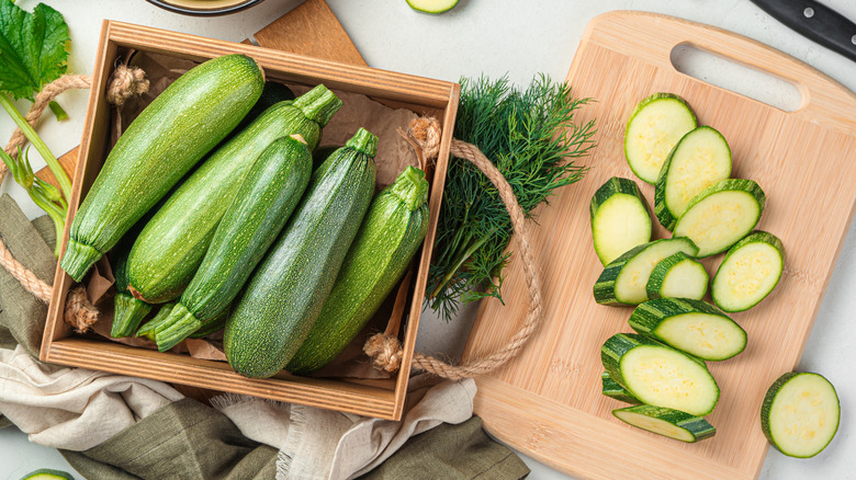 slicing zucchinis on cutting board