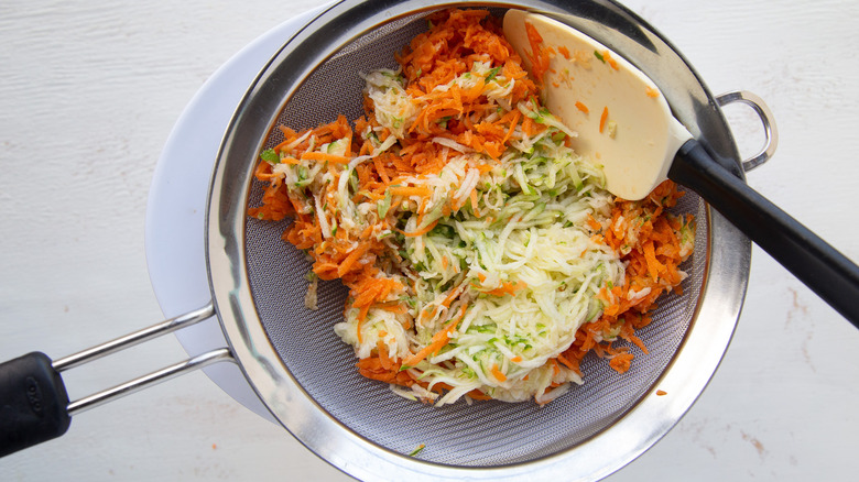 shredded veggies in colander 