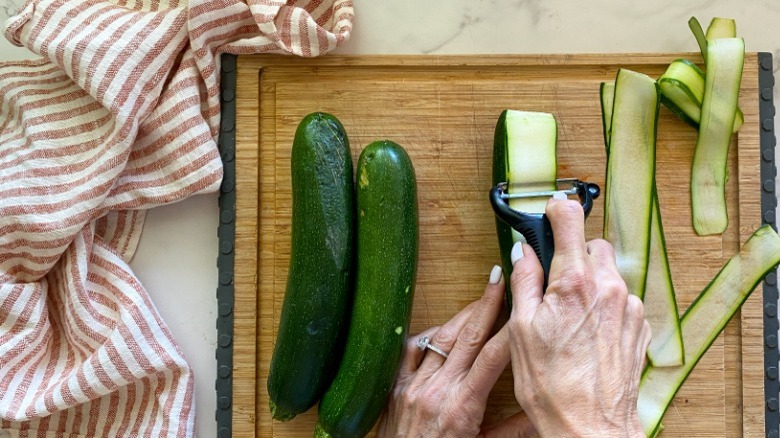 slicing the zucchini with peeler 