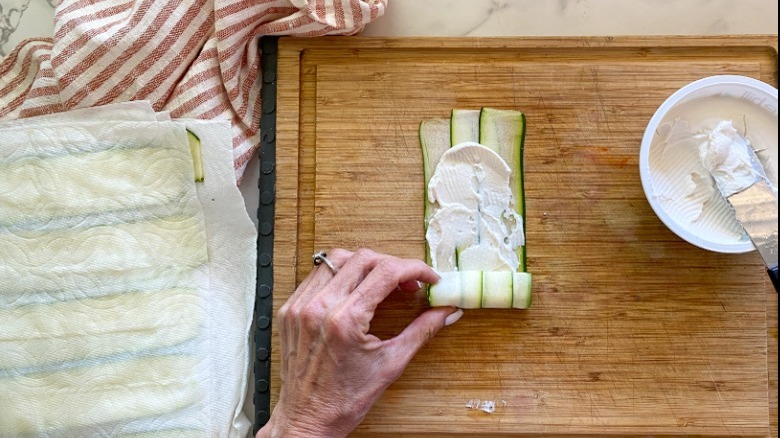 rolling up zucchini and cream cheese